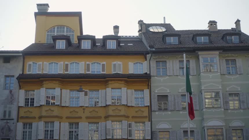 Two 3story buildings with a flag pole in front