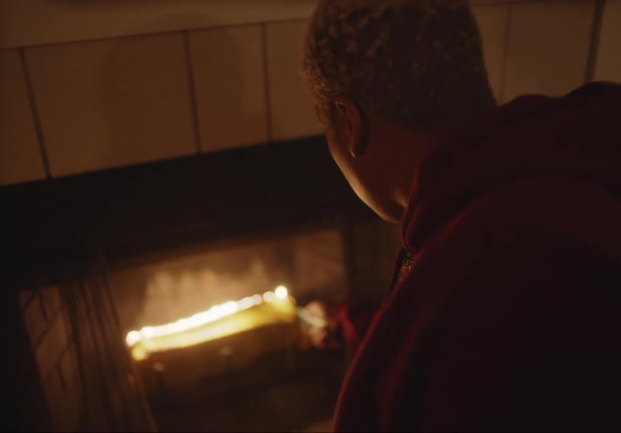 Woman lighting a fireplace with a lighter