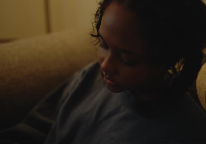 Woman sits and considers what she is viewing