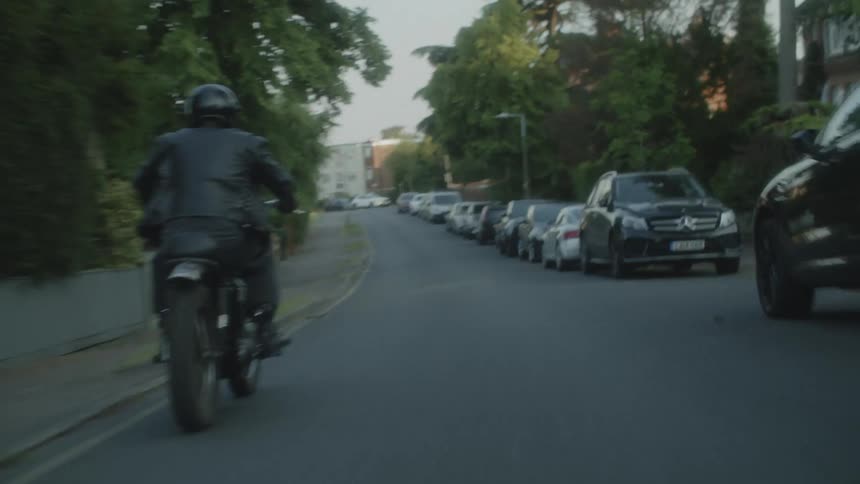 Man riding his motorcycle through an urban area