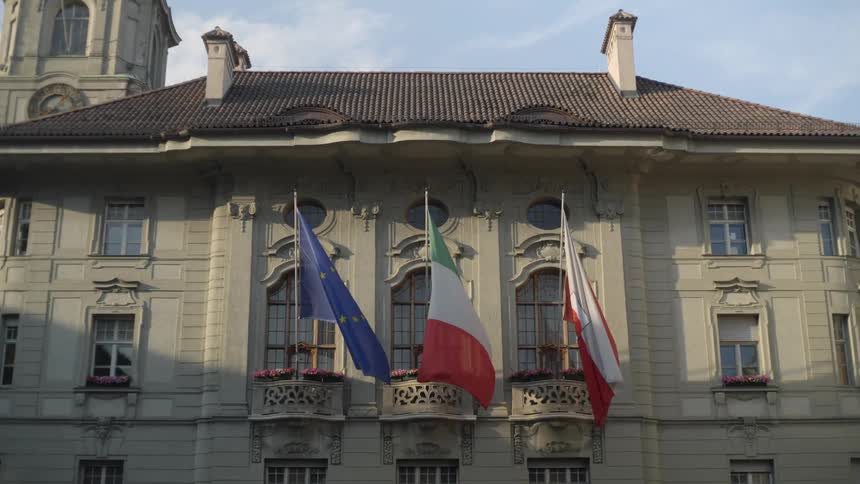 Building with old architecture and flags hanging from the balcony