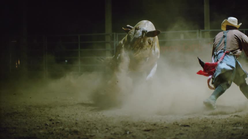 A man runs from a bucking bull