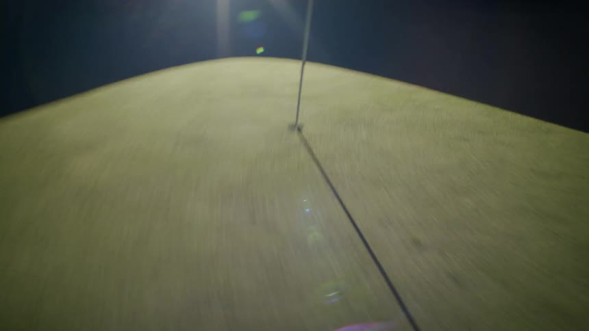 A white flag on a golf turf blowing in the wind