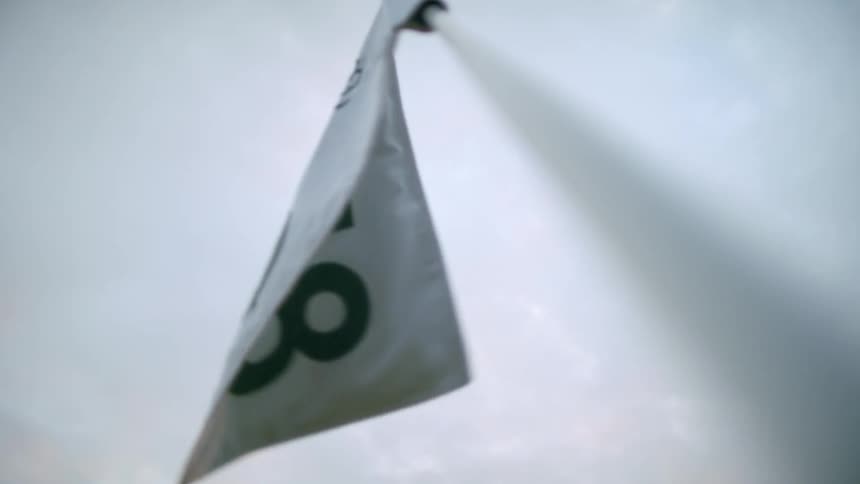 Closeup of a small white flag moving with the force of the wind