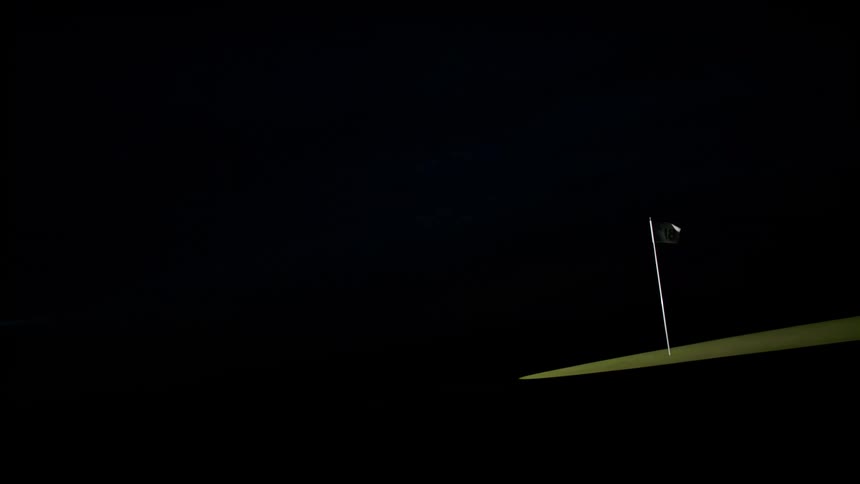 A flag waving against the wind in the dark night