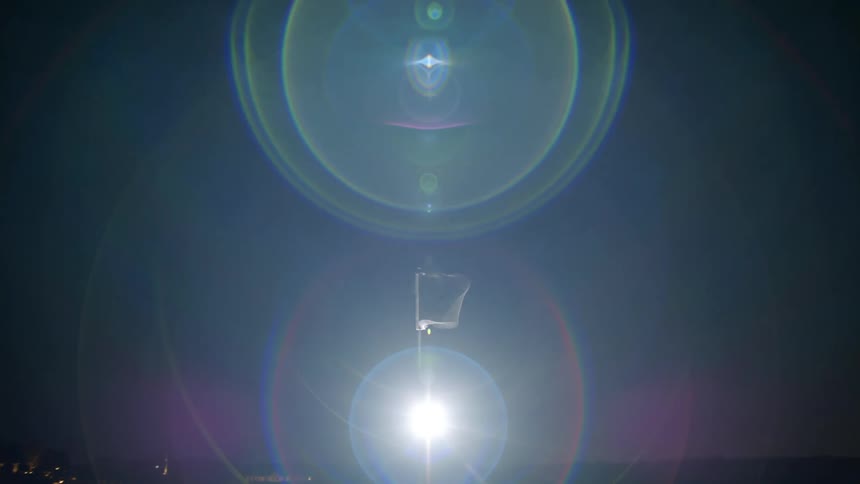 Abstract device in motion generating a beam of light and reflections