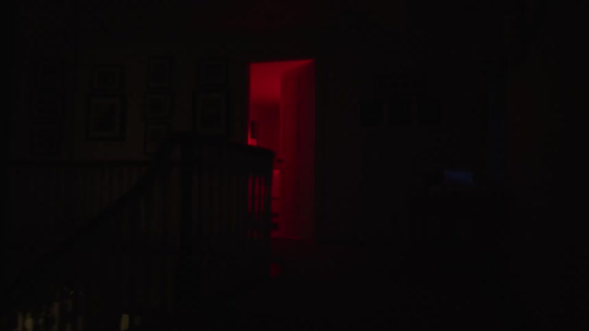 View of a room with an open door and a red light