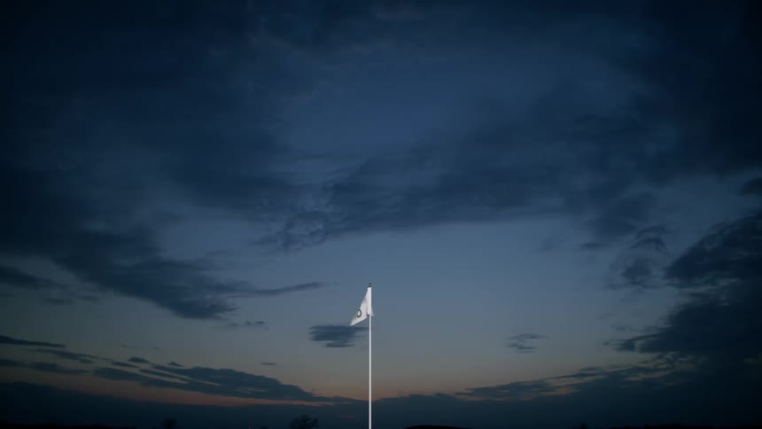 White flag waves on the wind at nightfall