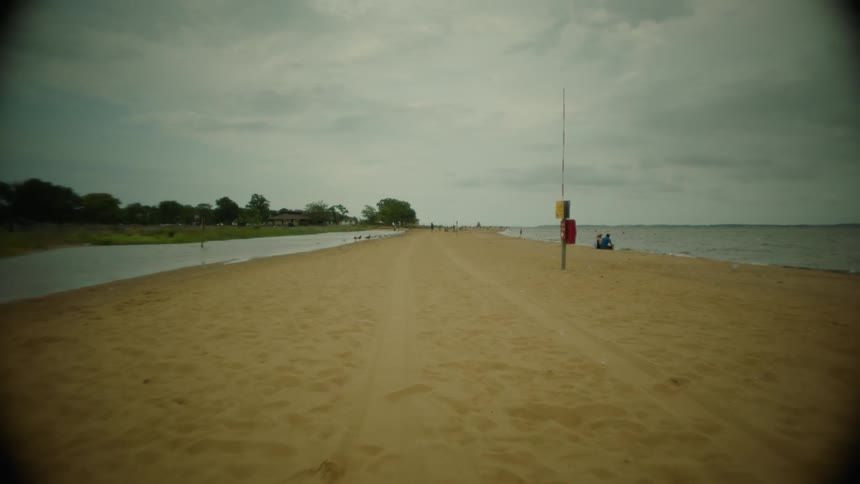 Yellow colored beach near the sea on a cloudy day