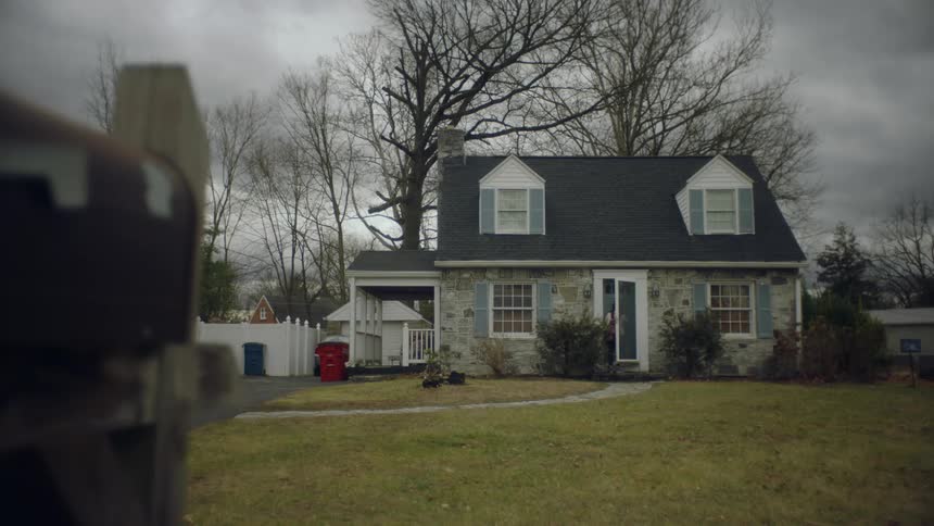 Woman walking towards the door of her house and entering