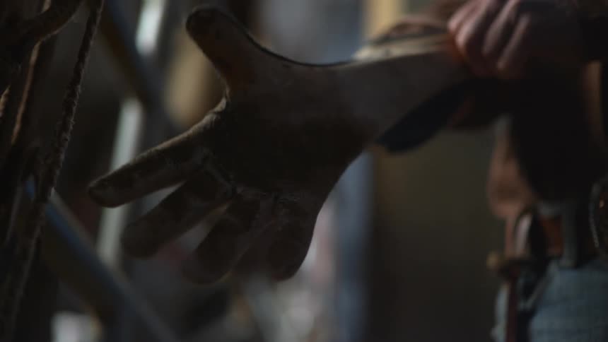 A man puts on a glove