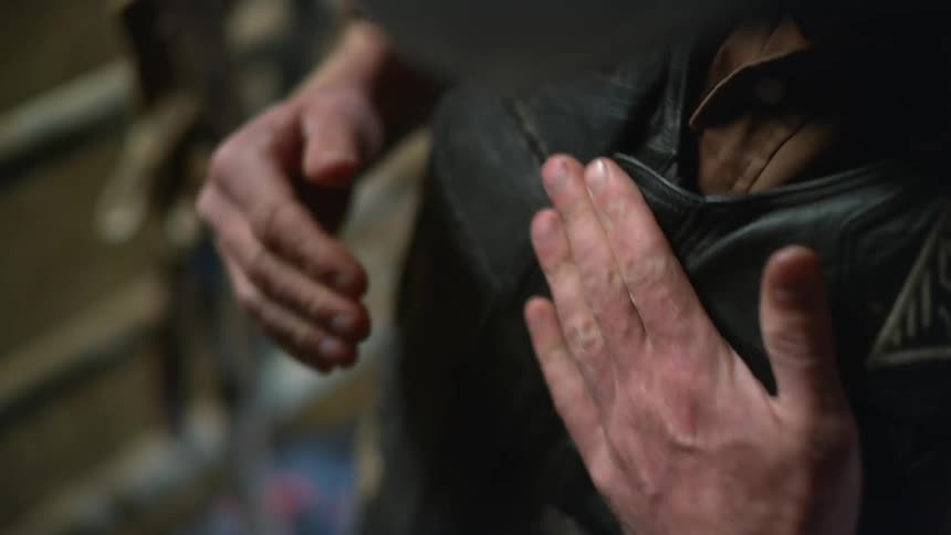 A man zips up his vest