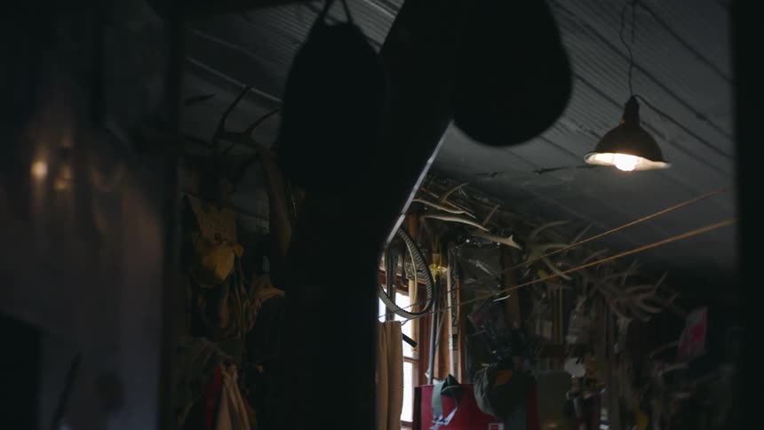 Indoor setting with various stored utensils and a lamp swaying in the wind