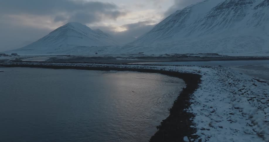 View of the ocean with snowcovered mountains in the background