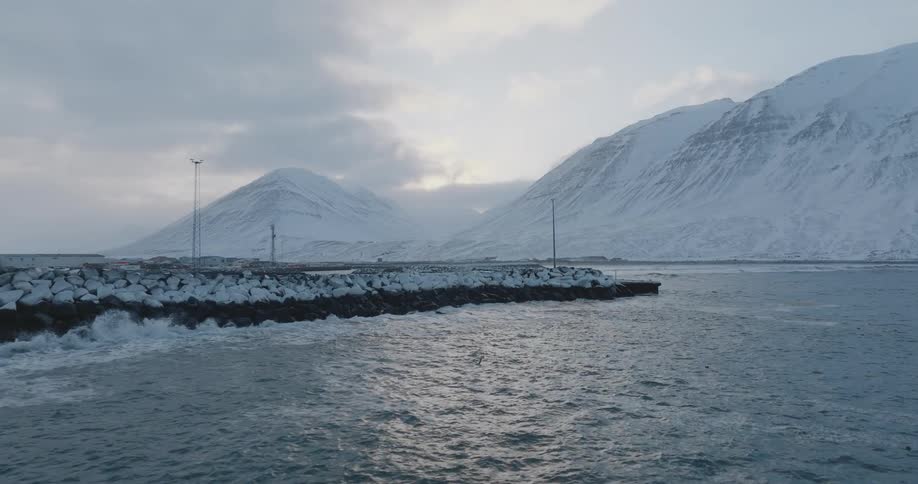 View of the ocean with snowcovered mountains in the background