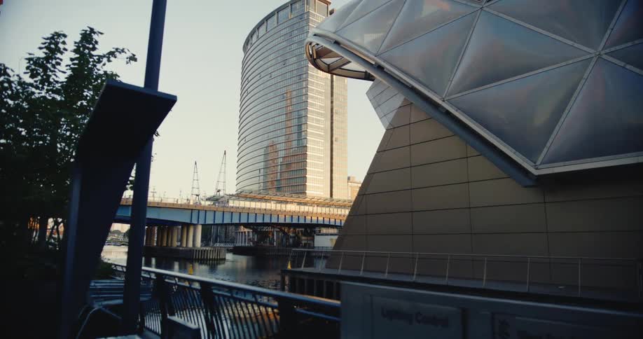View of a city by the seaside with architectural and mirrored buildings along with a bridge crossing the lake