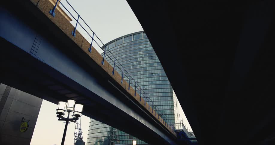 Bridge crosses over street between buildings