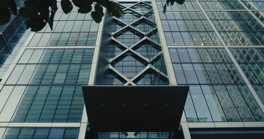 Glass facade of downtown skyscraper reflects nearby buildings