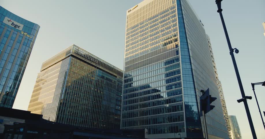 A tall building is surrounded by several others in a downtown area