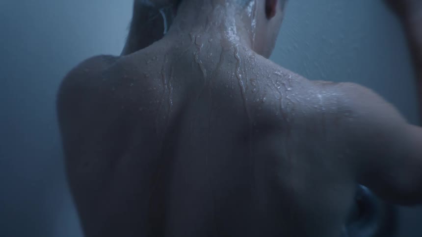 Water run down the back of a man taking a shower