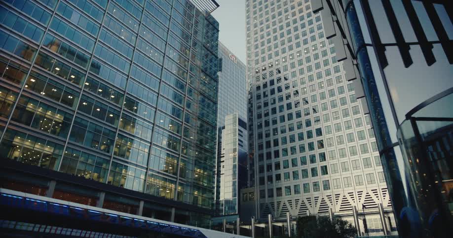 A view of several tall mirrored buildings
