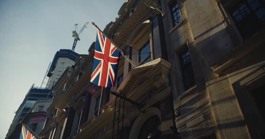 United kingdom flag hanging from the window of a building in the city