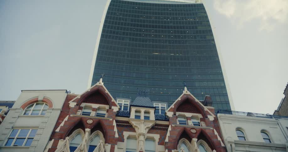 The boars head inn stands on a london street near a tall skyscraper