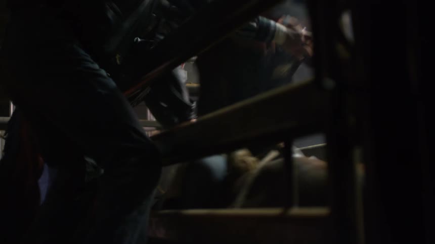 A man is tightening himself on a bucking bull
