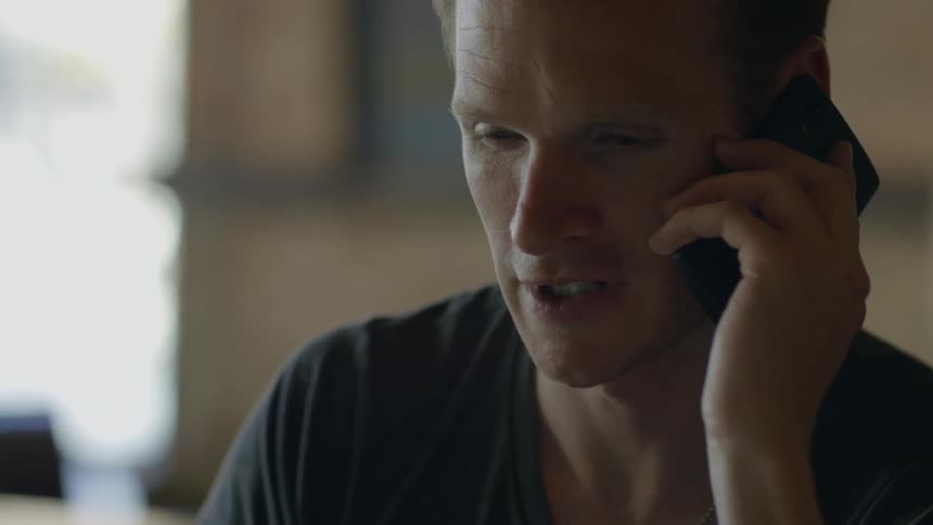 A man answers his phone