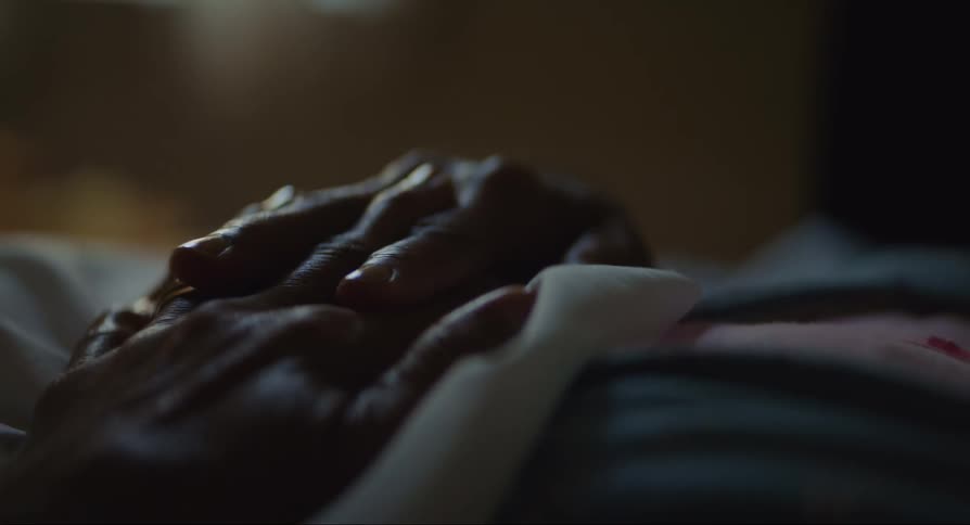 A pair of hands crosses fingers with each other