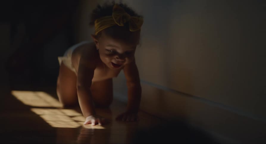 The baby is crawling on the floor