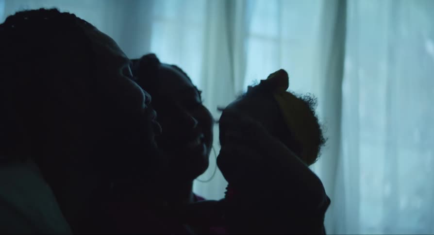 Portrait of parents holding their daughter and smiling happily