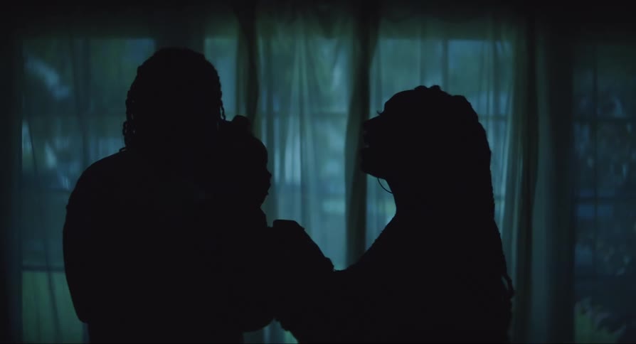 A family of a man and a woman with a child in their arms are playing