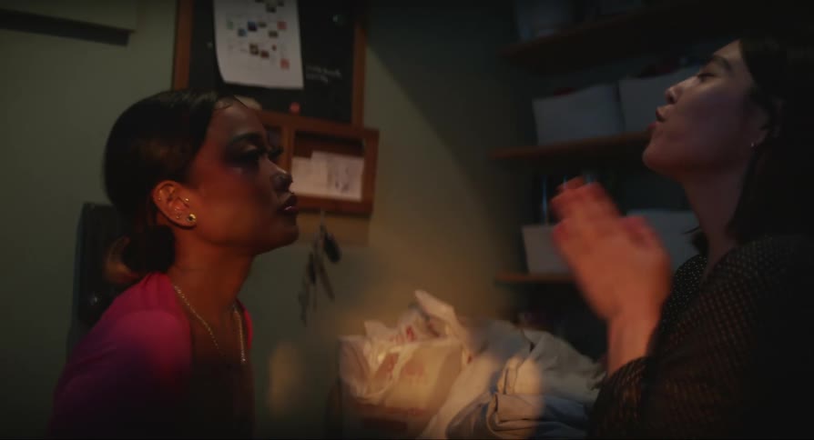 Two women arguing with each other in an indoor setting