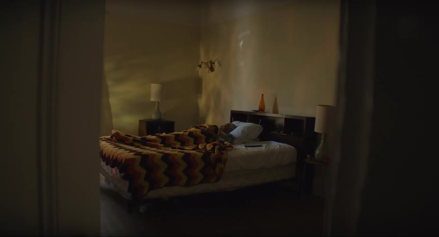Elderly person restlessly sleeping in a dimly lit bedroom