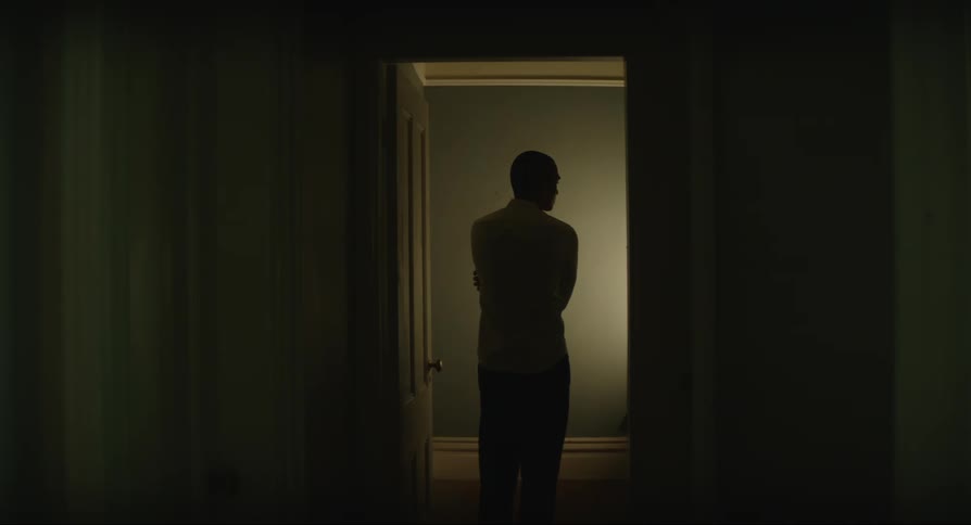 Man turns on lights in room to look around then turns lights off and leaves