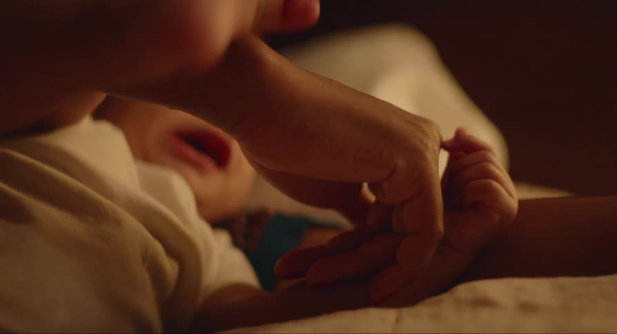 Mother resting in bed with her baby