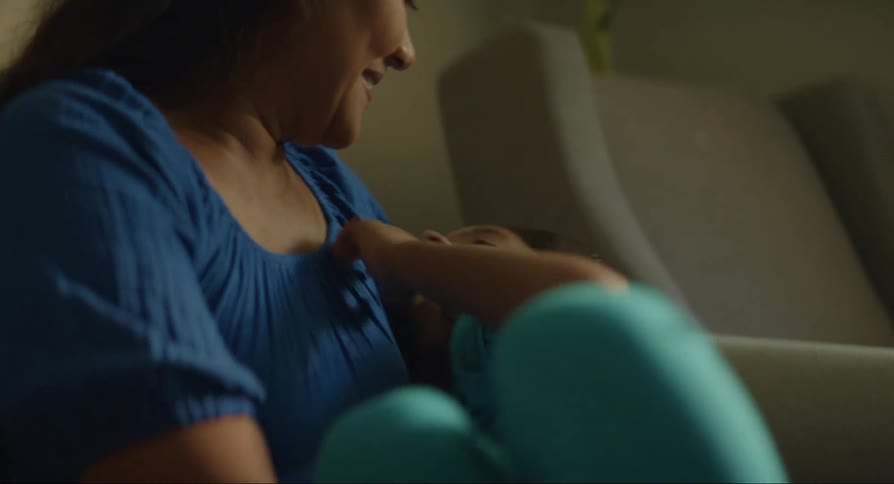 Mother and daughter hugging in an armchair
