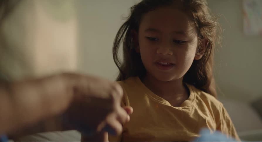 Girl holds out hand as person touches fingers