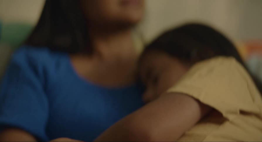 Daughter sits on mothers lap and naps