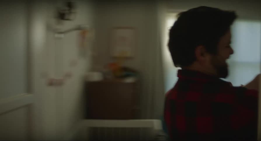 Father carries his son playfully through the house to change his diapers