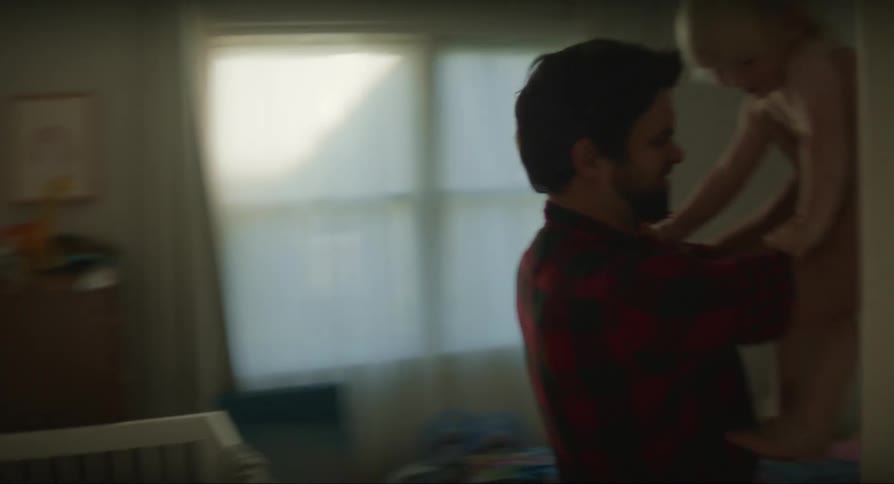 A father races his baby to another room to change his diapers