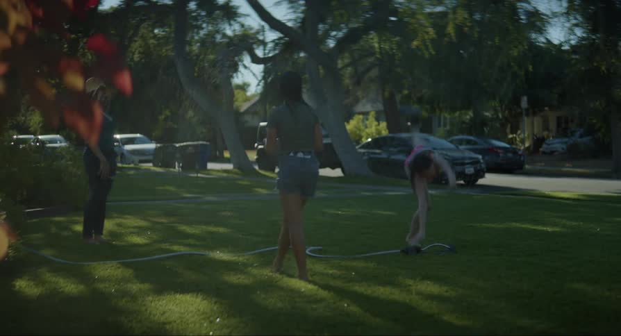 Children doing cartwheels in the backyard on a hot summer day