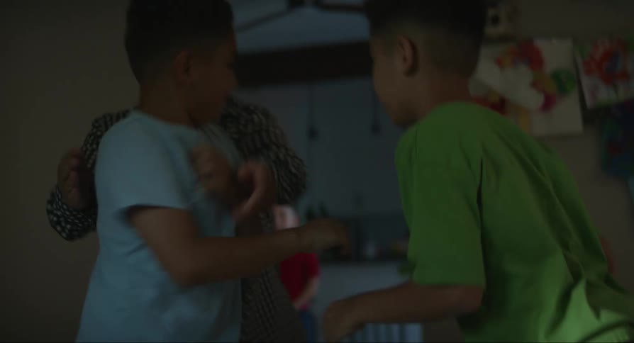 Mother drags her sons one by one out of the bedroom