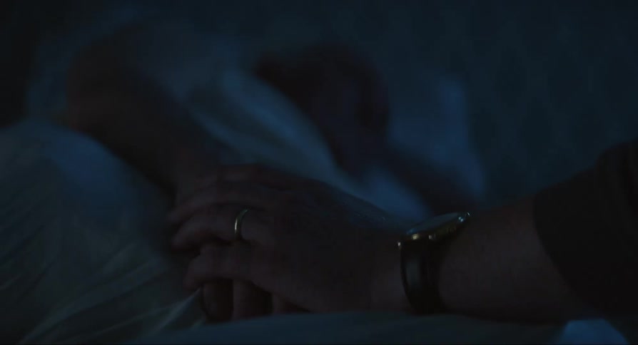 Person holds the hand of an elderly person sleeping