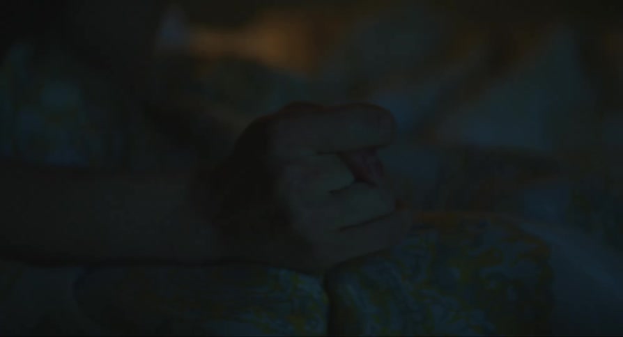 A person massaging their own hand using their fingers