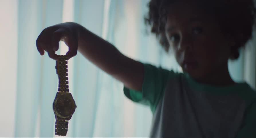 Boy holding a wristwatch and then letting it go