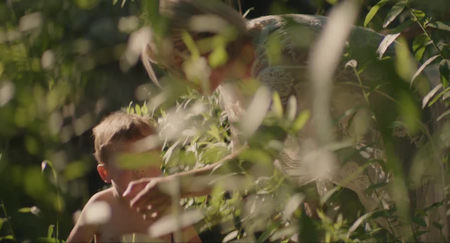 A woman with her child pointing to a plant