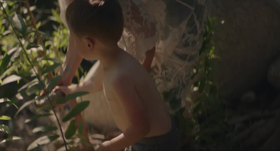 Mother and son play by the river in the forest