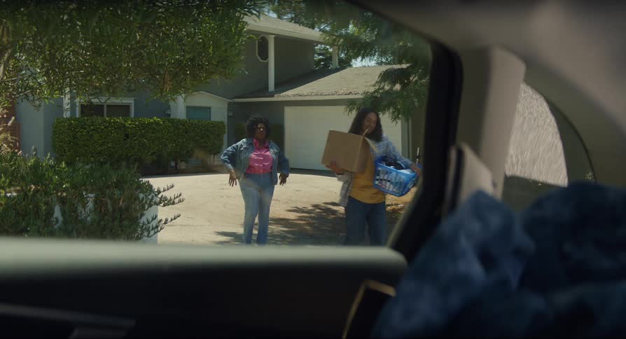 Mother helps son pack his things on the car